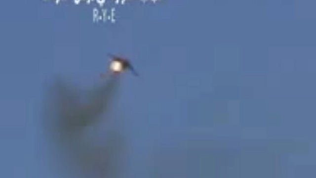 Syrian rebels claim this image, taken from a video, shows shows a government Soviet-made MiG warplane catching fire apparently after it was hit by ground fire. Syrian governments said the plane malfunctioned. 