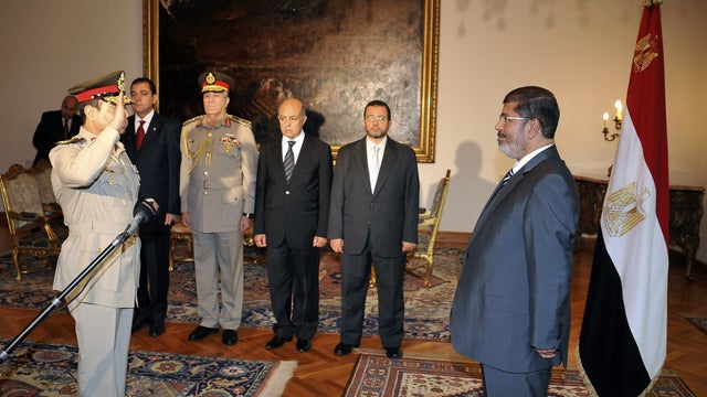 Egyptian President Mohammed Morsi, right, swears in newly-appointed Minister of Defense, Lt. Gen. Abdel-Fattah el-Sissi, left, in Cairo, Egypt, Sunday, Aug. 12, 2012. 