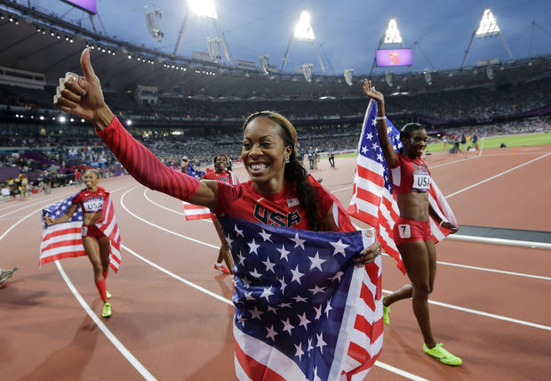 United States' Deedee Trotter, right, United States' Sanya Richards-Ross, front center and United States' Allyson Felix, back left, celebrate winning gold  