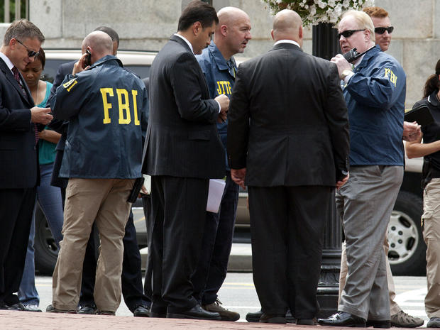 Washington police and FBI agents gather outside the Family Research Council in Washington Aug. 15, 2012, after a security guard at the lobbying group was shot in the arm. 
