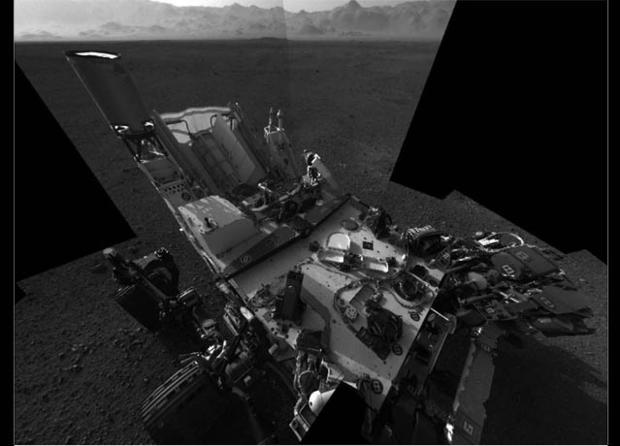 This full-resolution self-portrait shows the deck of NASA's Curiosity rover from the rover's Navigation camera. The back of the rover can be seen at the top left of the image, and two of the rover's right side wheels can be seen on the left. The undulatin 