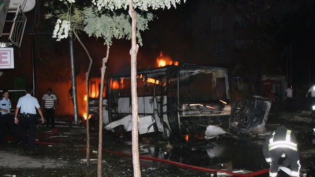 Firefighters and police officers seen after an explosion near a police station in southern Turkish city of Gaziantep, Turkey, late Monday, Aug. 20, 2012.  