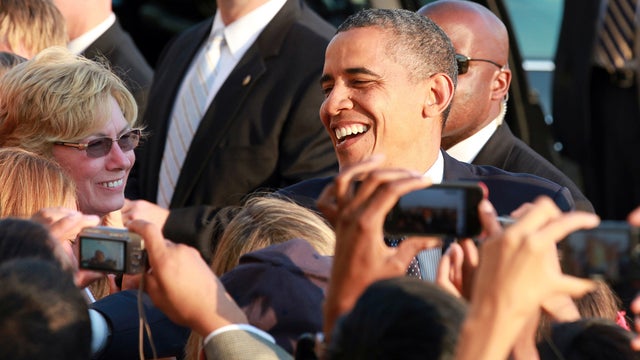 President Obama greets well-wishers as he arrives at JFK International Airport in New York Wednesday 