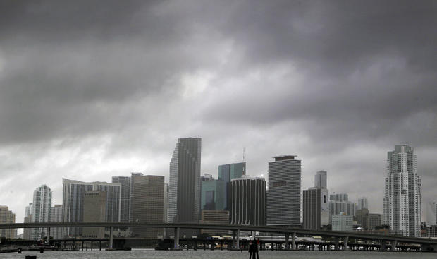 Heavy storm clouds hover over the skyline of downtown Miami  