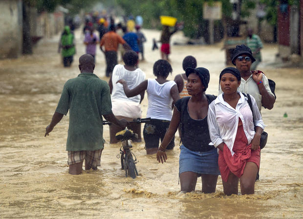 Residents of Cite Soleil wade through floodwaters 