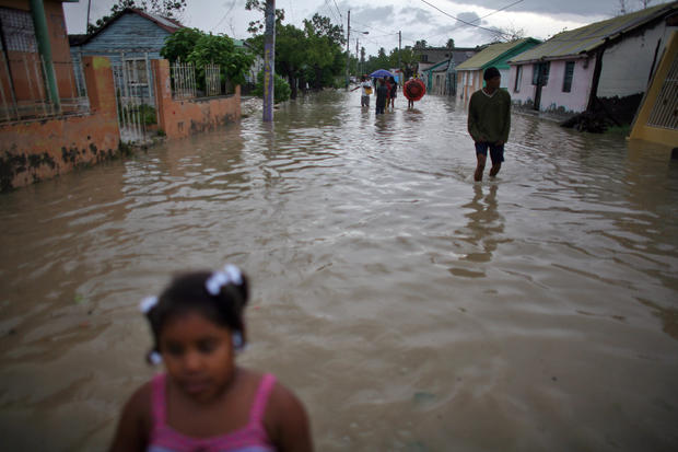 People walk thru flooded streets after Tropical Storm Isaac hit in Barahona, Dominican Republic 