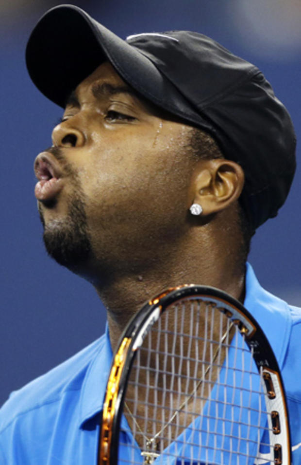 Donald Young reacts after losing a point to Roger Federer 