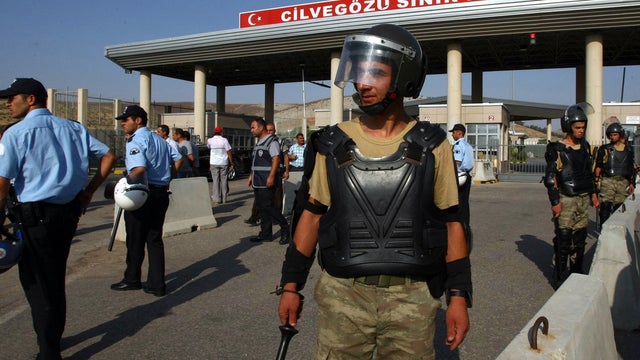 Turkish soldiers stand guard at the border 
