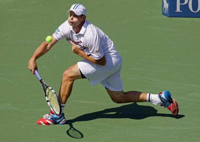 Andy Roddick returns a shot  