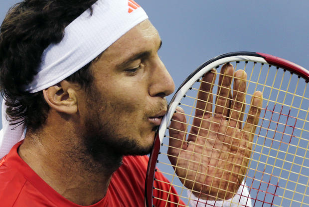 Juan Monaco, of Argentina, kisses his racquet during his match  
