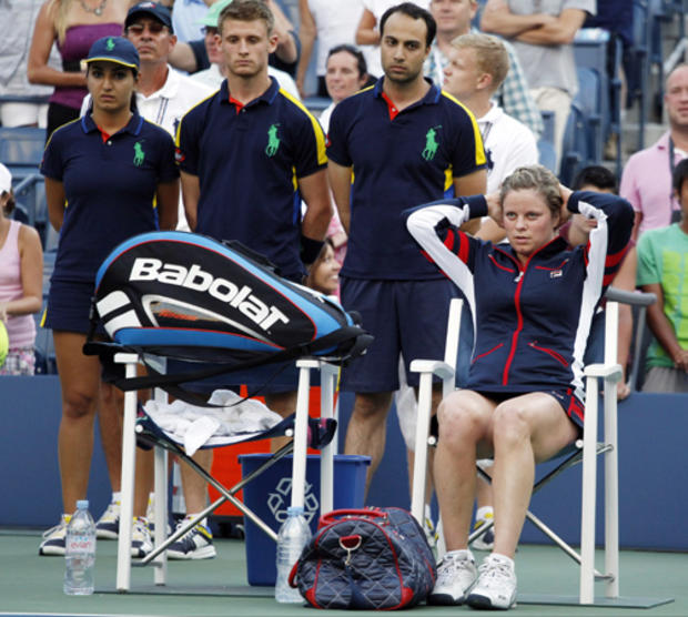 Kim Clijsters  sits on the side of the court after losing to Laura Robson 
