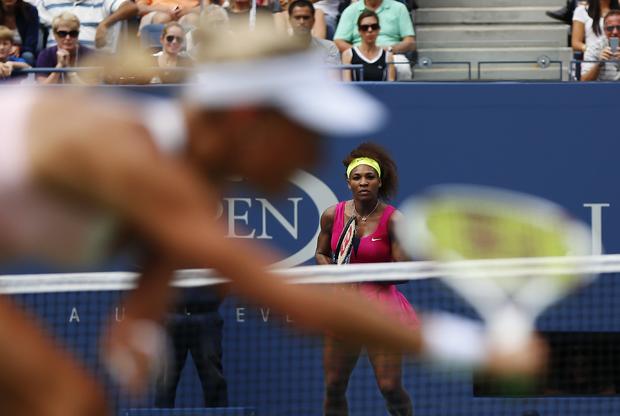 Andrea Hlavackova returns a shot to Serena Williams  