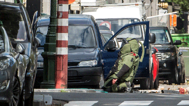 A Belgian bomb squad member inspects a suspicious vehicle near to the U.S. embassy in Brussels, Wednesday, Sept. 5, 2012.  