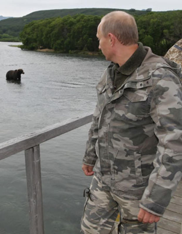 Vladimir Putin looks at a bear at the South Kamchatka Sanctuary 