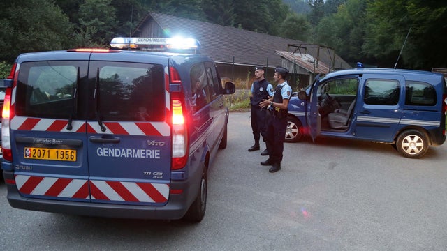 Gendarmes block access to a murder scene near Chevaline, in the French Alps 