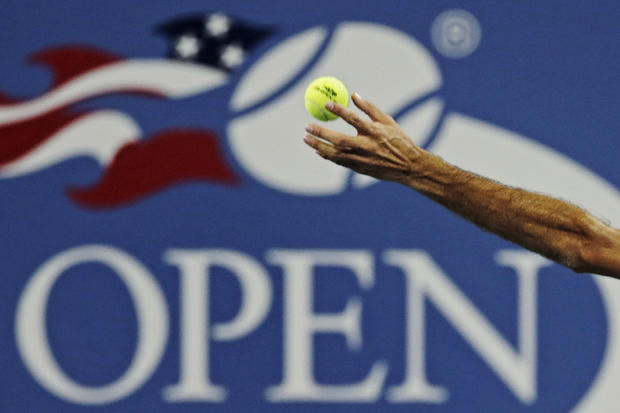 Roger Federer tosses the ball on his serve 