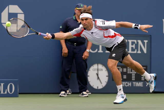 David Ferrer returns a shot against Janko Tipsarevic 