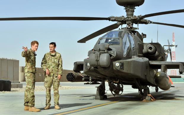 Prince Harry, left, being shown Apache flightline by member of his squadron at Camp Bastion in Helmand Province, Afghanistan on Sept. 7  