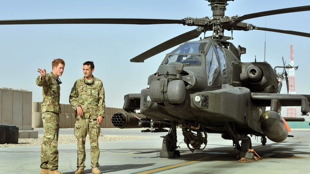 Prince Harry, left, being shown Apache flightline by member of his squadron at Camp Bastion in Helmand Province, Afghanistan on Sept. 7  