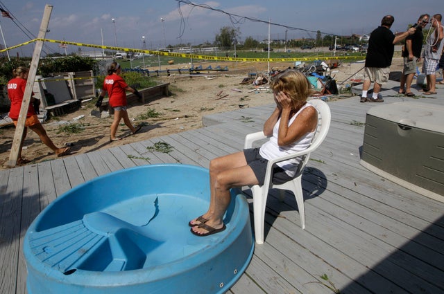 abana owner Janet Ryan is overcome by emotion as she sits on the porch at the Breezy Point Surf Club in New York, Saturday, Sept. 8, 2012, after a severe weather storm 
