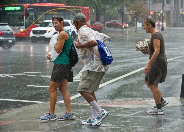 People brave the weather during a heavy rainstorm in Washington on September 8, 2012. Severe thunderstorms hit the region and a tornado hit Fairfax County in nearby Virginia but no damage or casualties were reported, according to local media. 