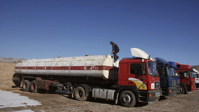 Empty fuel tankers sit on the Afghan side of a border crossing to Iran, in Herat province, west of Kabul, Afghanistan. 