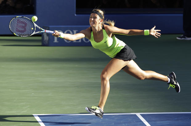 Victoria Azarenka returns a shot to Serena Williams 