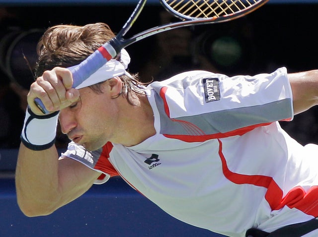 David Ferrer returns a shot to Serbia's Novak Djokovic 