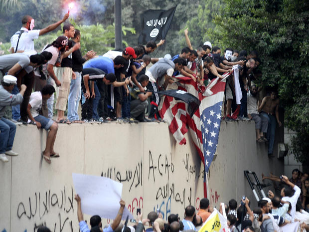 Protesters destroy an American flag pulled down from the U.S. Embassy in Cairo Sept. 11, 2012. 