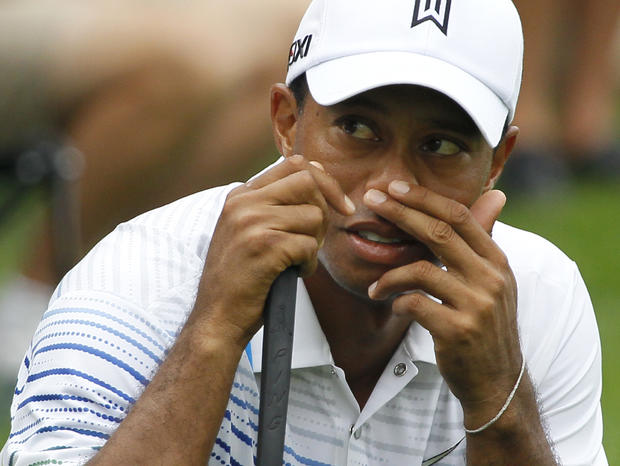 Tiger Woods looks at the scoreboard 