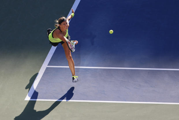 Victoria Azarenka returns a shot to Serena Williams 
