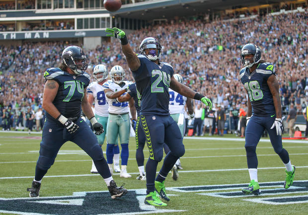 Marshawn Lynch tosses the ball away after scoring 