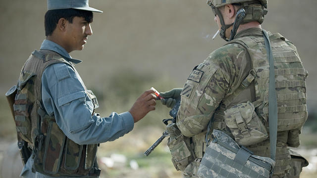 A U.S. Army soldier on joint patrol with an Afghan National Police officer 