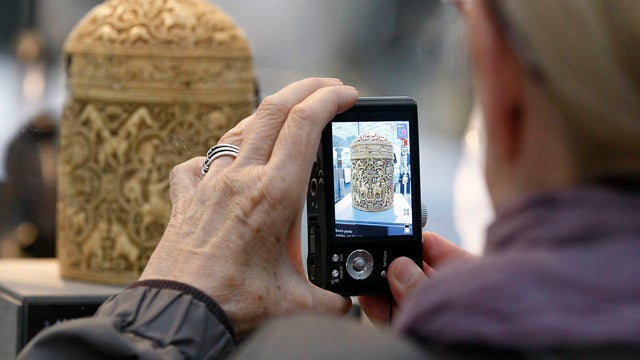 A member of the media takes a snapshot of a 4th century Ivory box 