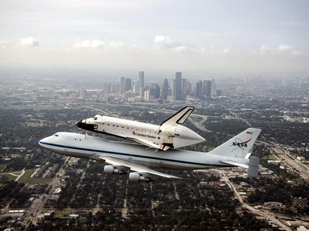 Space Shuttle Endeavour is ferried by NASA's Shuttle Carrier Aircraft (SCA) over Houston, Texas on September 19, 2012, during a three-day flight to Los Angeles, where the shuttle will be put on public display at the California Science Center. 