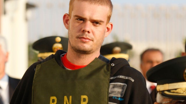 June 2010 file photo shows Joran van der Sloot being escorted by police outside Peruvian police station 