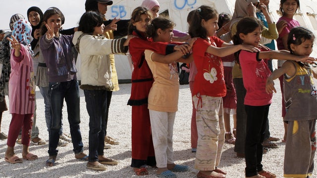 Syrian refugee children stand in line before attending class at the Zaatari Syrian refugee camp in Mafraq, Jordan, in this Thursday, Oct. 4, 2012 photo. 