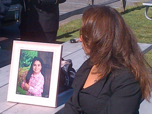 Lisa Gaines Looking At Photo Of Her Daughter Victoria 