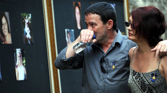 Relatives mourn near pictures of victims of the 2002 Bali bombings 