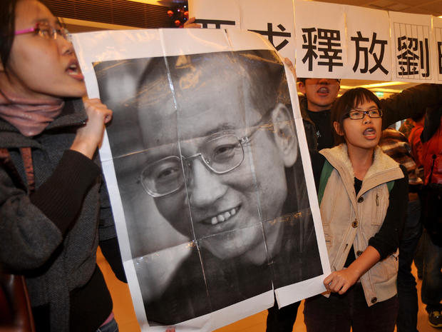 Demonstrators hold a portrait of China's detained Nobel Peace Prize winner Liu Xiaobo 