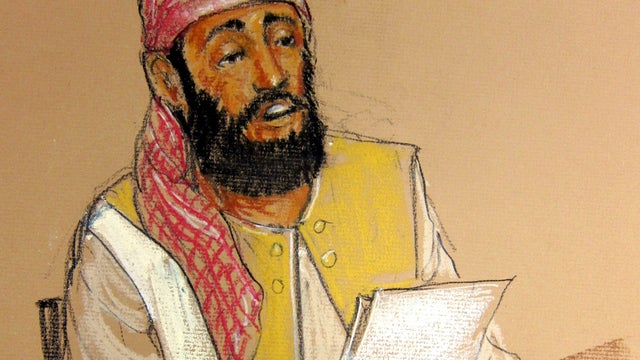Ramzi Binalshibh, one of the five Guantanamo Bay prisoners charged in the Sept. 11 attacks, sits at defense table holding document during military tribunal pretrial hearing Monday 