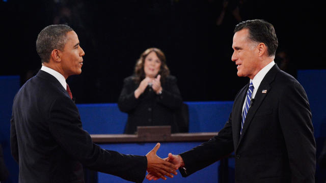 Moderator Candy Crowley, center, applauds as President Barack Obama, left, shakes hands with Republican presidential nominee Mitt Romney 