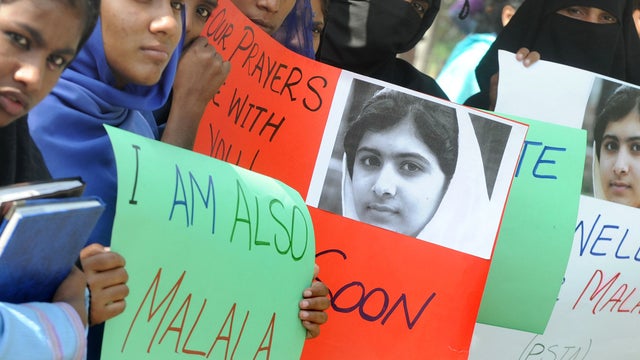Pakistani students carry placards with the photograph of child activist Malala Yousufzai during a protest in Lahore, Pakistan, Oct. 16, 2012, against the Taliban's assassination attempt on her. 