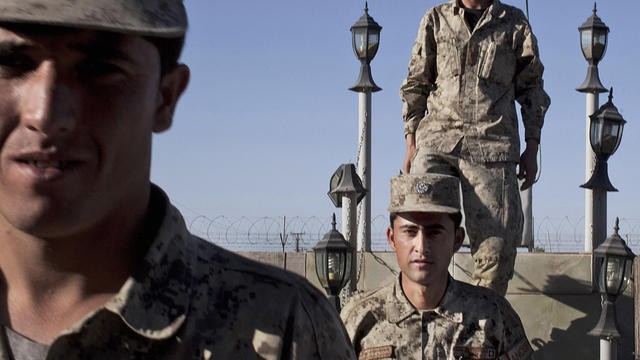 Afghan National Police line up after the official ceremony to take down the flag at the end of the day at their base in Lashkar Gah, Helmand, Afghanistan, Wednesday, Oct. 17, 2012. In eastern Afghanistan a suicide car bomber blew up his vehicle near the g 