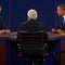 Image from third and final presidential debate shows moderator Bob Schieffer, of CBS News, with back to camera, Mitt Romney on left and President Obama on right  