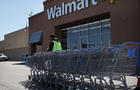 A man pushes carriages outside of a Walmart store on March 29, 2011, in Valley Stream, N.Y. 