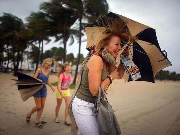 Laura Rath, on vacation from the Netherlands, walks on the beach with her family as they are buffeted by high winds of the outer bands of Hurricane Sandy on October 25, 2012 in Miami Beach, Florida. 