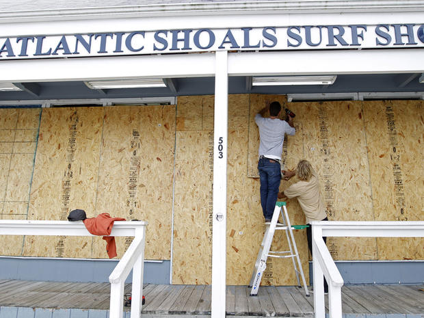 Surf store workers prep windows in Ocean City, Md., ahead of Hurricane Sandy. 