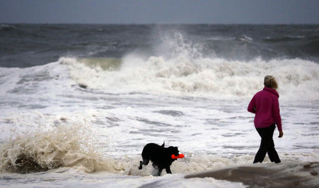 Annemarie Jarman, and her dog "Bruges," walk along the edge of the beach in Ocean City, Md. 