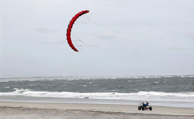 People ride in carts pulled by the winds along the Atlantic Ocean in North Wildwood, N.J. 